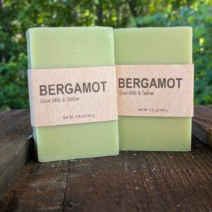 Two bars of bergamot-scented soap standing on end next to each other.