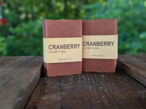 Two bars of cranberry soap, standing on end next to each other.